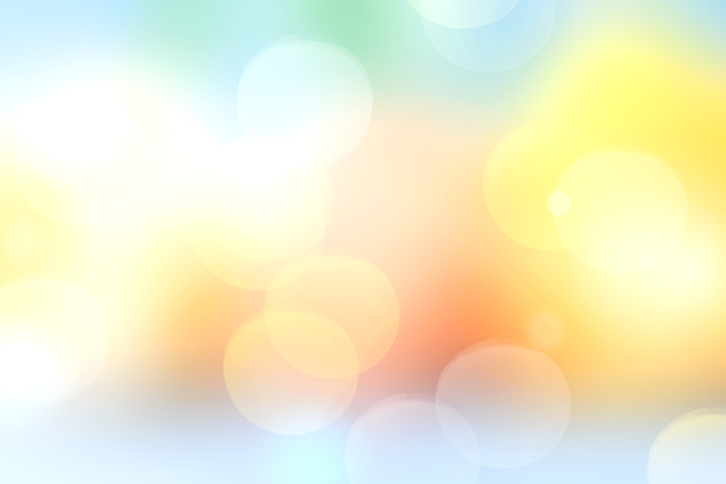 Soft yellow blurred bokeh background texture.